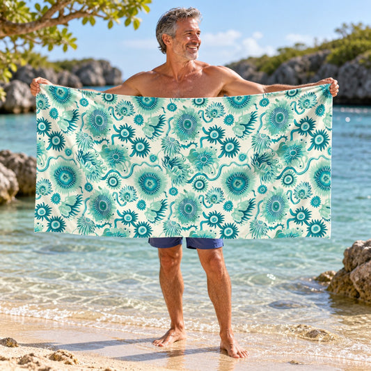 Surreal Sea Garden beach towel, shown with an adult in a summer setting.