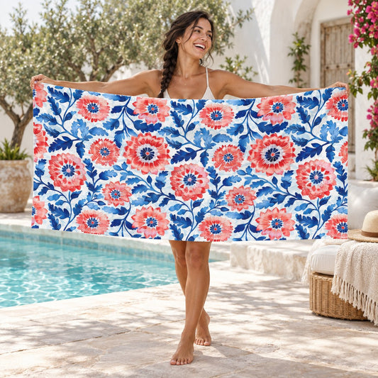 Whimsical Batik Blossoms beach towel, shown with an adult in a summer setting.