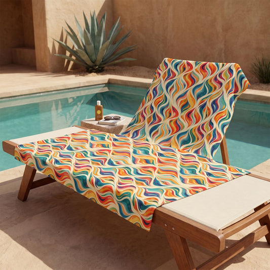 Modern Art Flames beach towel, displayed in a summer setting.