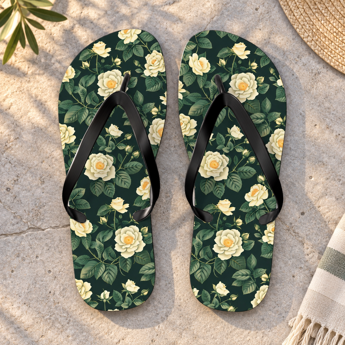 White Roses at Dusk Flip Flops, product-only overhead view with the printed pattern clearly visible. Setting: pale grey stone terrace in soft evening light.