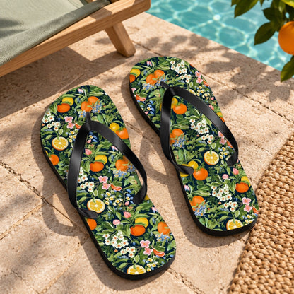 Noble Citrus Mosaic Flip Flops. Lifestyle scene: Orange-grove poolside pavilion; dry warm limestone, sage canvas chair, citrus shade