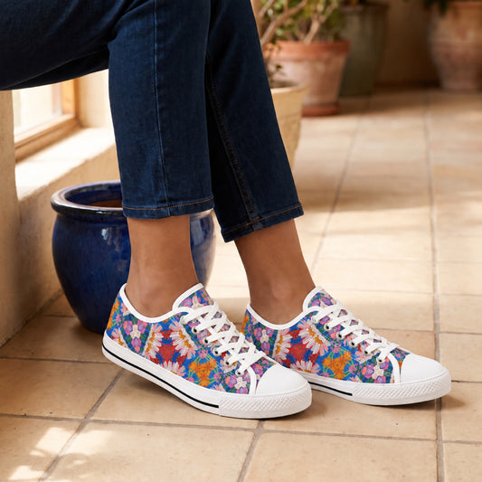 Geometric Blossom Ladies' Low Top Sneakers. Lifestyle scene: Artisan tiled passage; warm cream paving, deep blue glazed pots, side-window glow