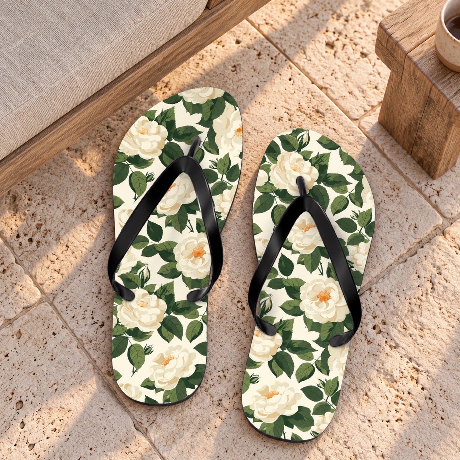 White Roses at Dawn Flip Flops. Lifestyle scene: Dawn beach-house patio; dry ivory limestone, oatmeal lounge chair, gentle peach morning light