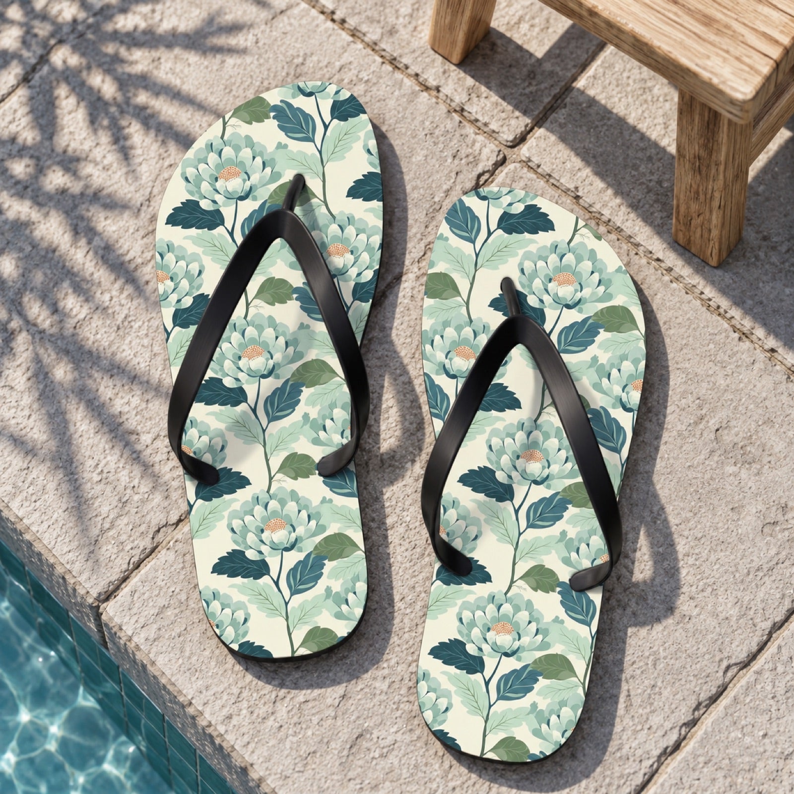 Zen Flower Flip Flops. Lifestyle scene: Zen courtyard plunge pool; dry light grey stone, bamboo shadow, simple wood stool