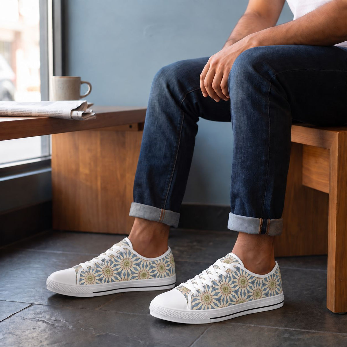 Celestial Harmony Men's Low Top Sneakers. Lifestyle scene: University observatory visitor café; dark stone floor, warm wood bench, subtle celestial-blue wall