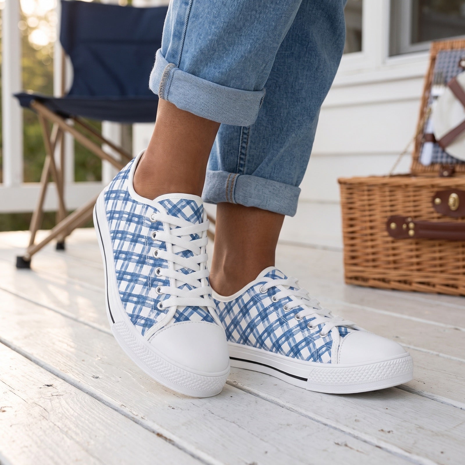 Blue Breeze Gingham Ladies' Low Top Sneakers — Lakeside cottage porch; white painted boards, navy canvas chair, wicker picnic hamper