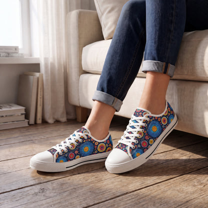 Primordial Space Life Ladies' Low Top Sneakers. Lifestyle scene: Book-filled studio window nook; weathered oak, cream linen lounge seat, daylight through sheer curtain