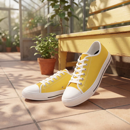 Daffodil Men's Two-Tone Low Top Sneakers. Lifestyle scene: Sunny greenhouse walkway lounge; clean pale tiles, butter-yellow bench, diffuse leaf shadows
