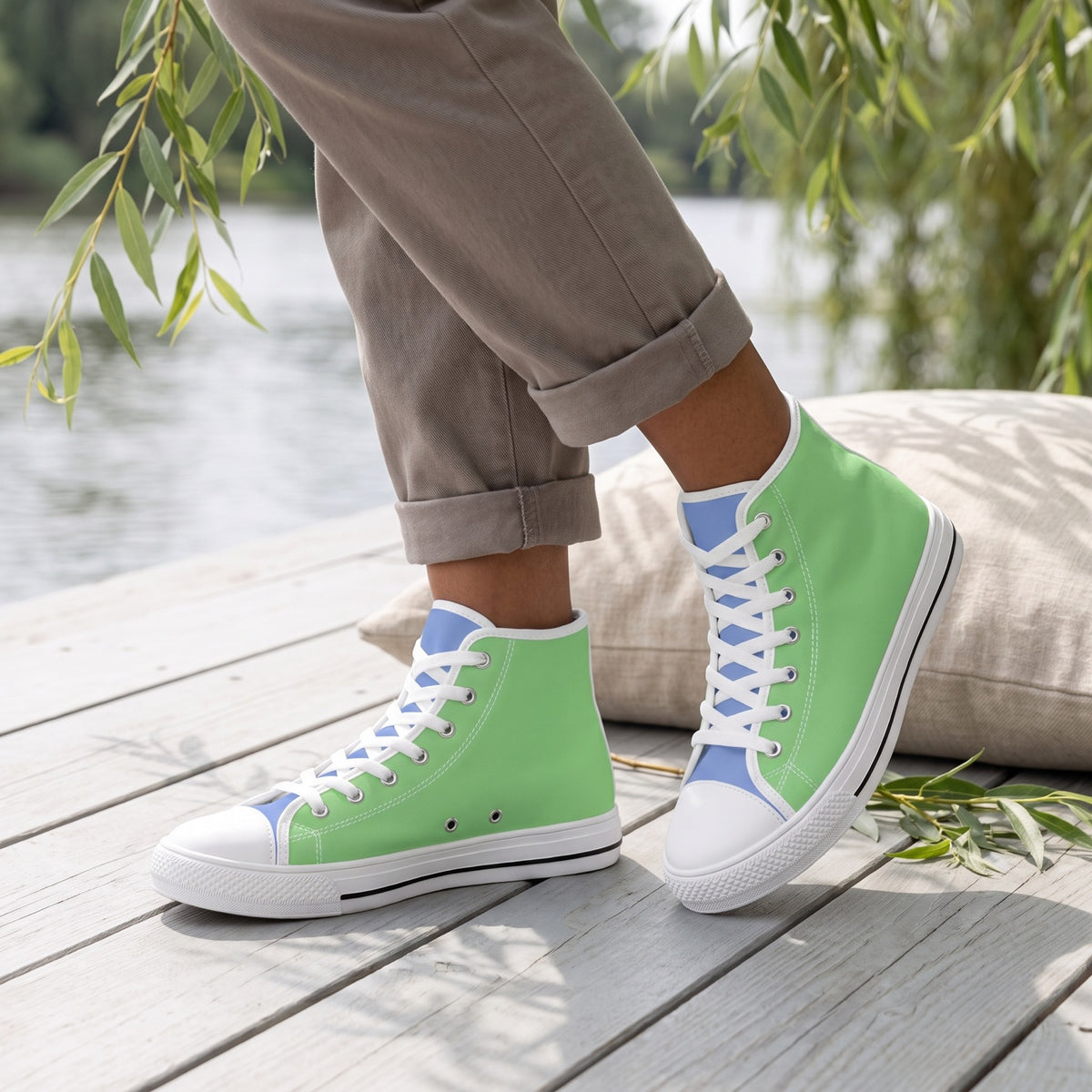 Meadow Stream Ladies' Two-Tone High Top Sneakers. Lifestyle scene: Riverfront reading terrace; pale grey decking, willow shade, oatmeal linen cushion