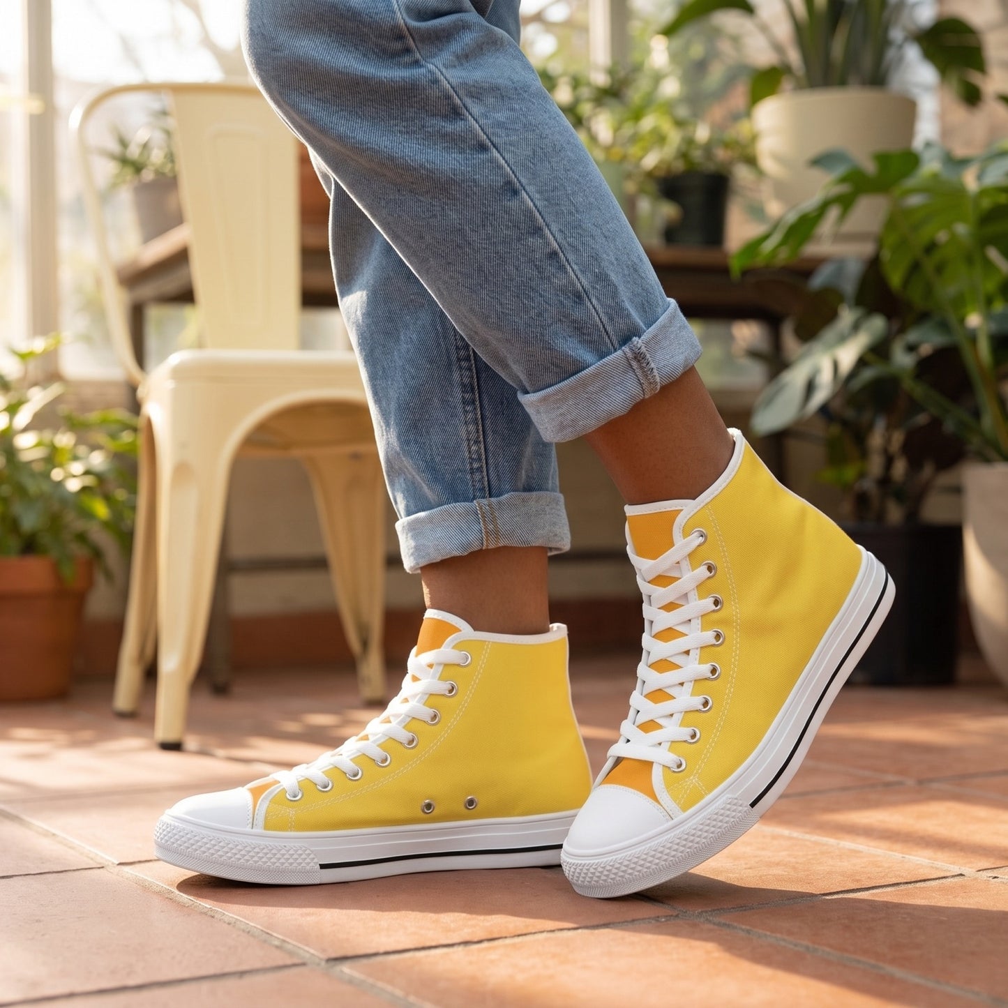 Daffodil Ladies' Two-Tone High Top Sneakers. Lifestyle scene: Sunlit greenhouse café; terracotta tiles, buttercream metal chair, plants in far background