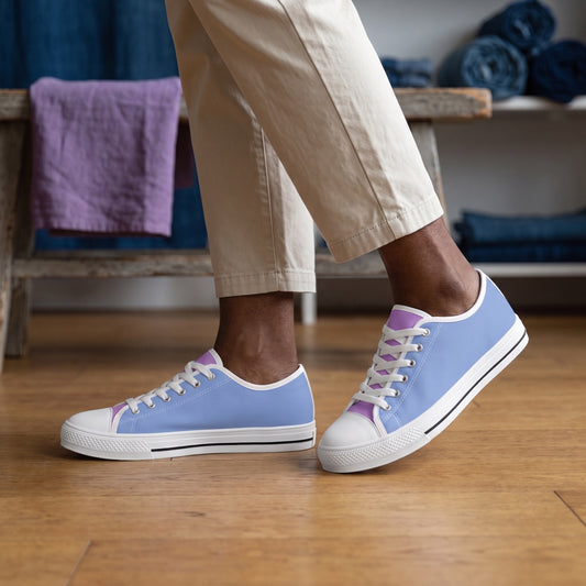 Purple Daze Ladies' Two-Tone Low Top Sneakers. Lifestyle scene: Indigo-dyed textile studio; warm oak floor, violet linen swatch folded on bench, soft north light