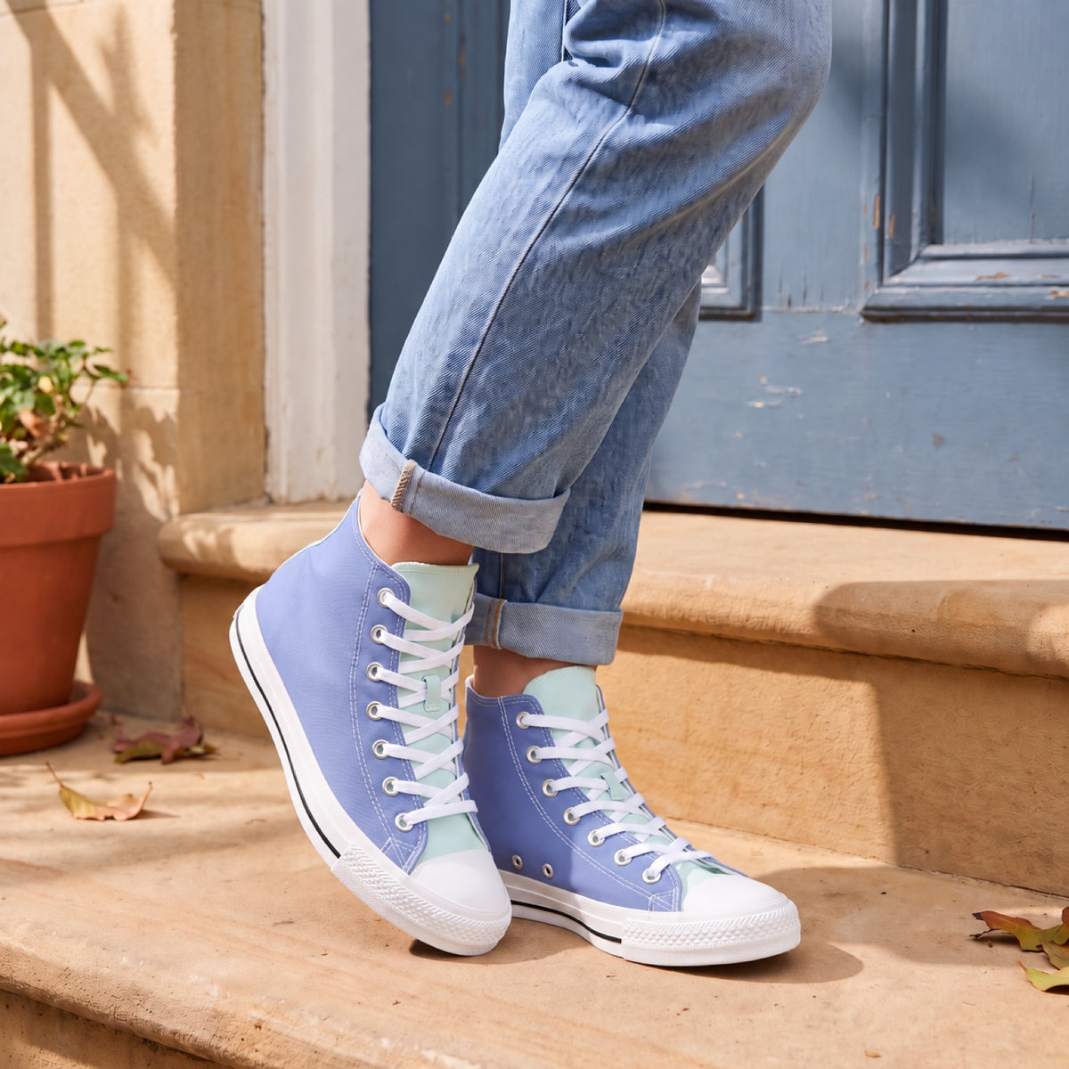 Turquoise Breeze Ladies' Two-Tone High Tops. Lifestyle scene: Blue-door townhouse stoop; warm sandstone, aged blue painted door, midday soft shade