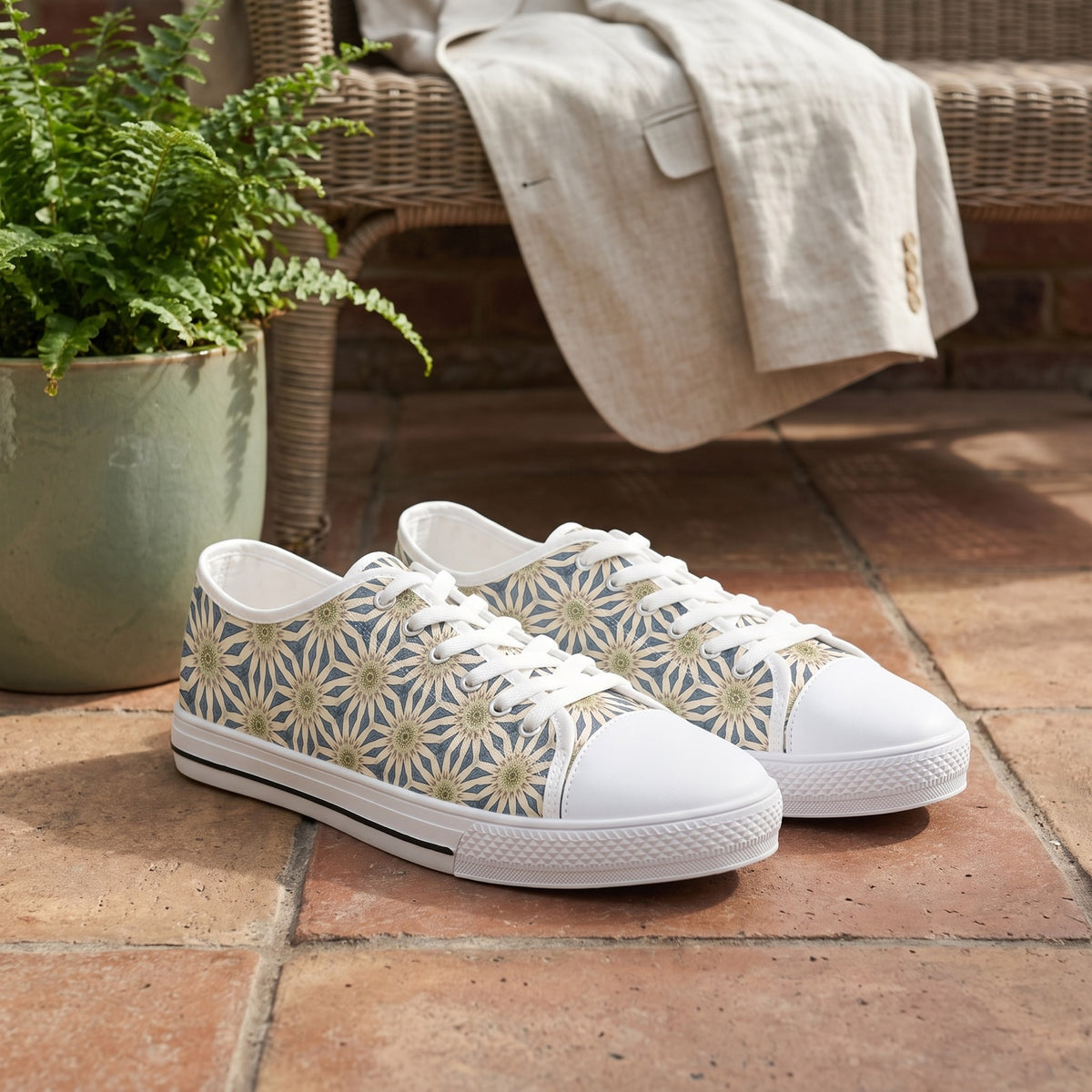 Celestial Harmony Men's Low Top Sneakers — A sunlit botanical conservatory entrance at late morning, shoes placed together on dry old terracotta beside a woven garden bench.