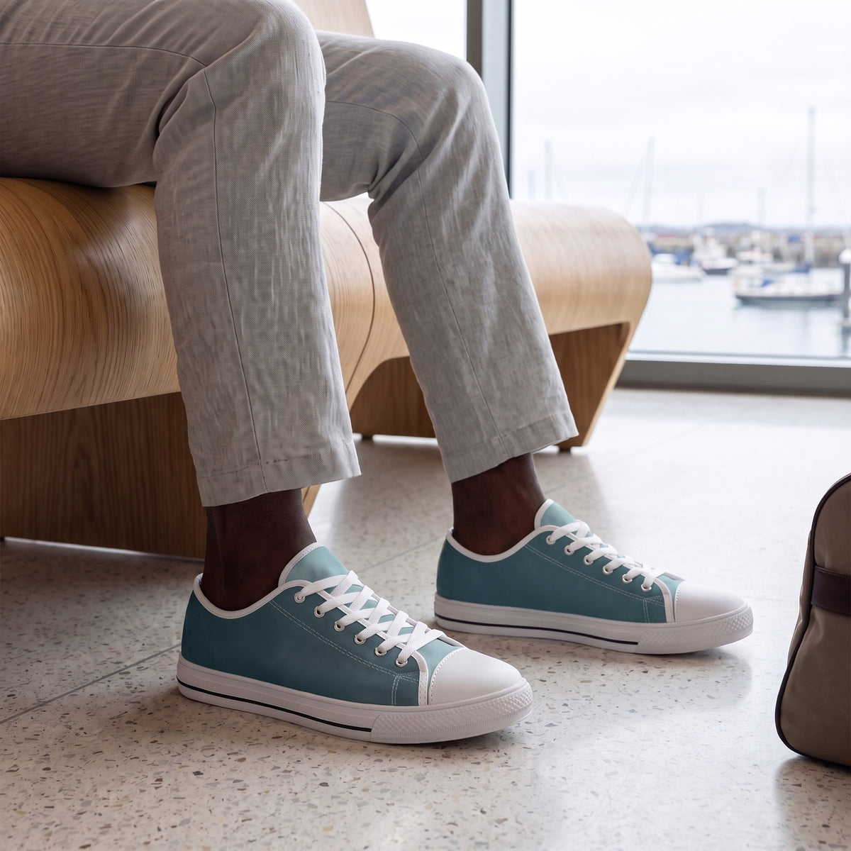 Arctic Ocean Men's Two-Tone Low Top Sneakers — A harbour ferry terminal lounge on a bright overcast morning, an intimate view of a man waiting by a broad window.