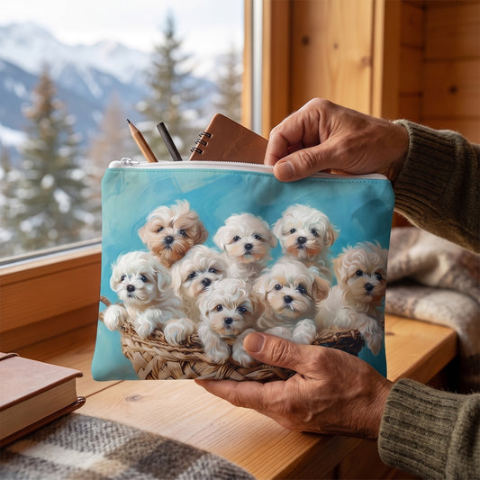 Large Basket of Puppy Love accessory pouch (11.81 × 8.35 inches) in use: older man's hands pack a pencil pouch selection of drawing tools and small journal for sketching the view. Lifestyle mockup with hands showing scale.