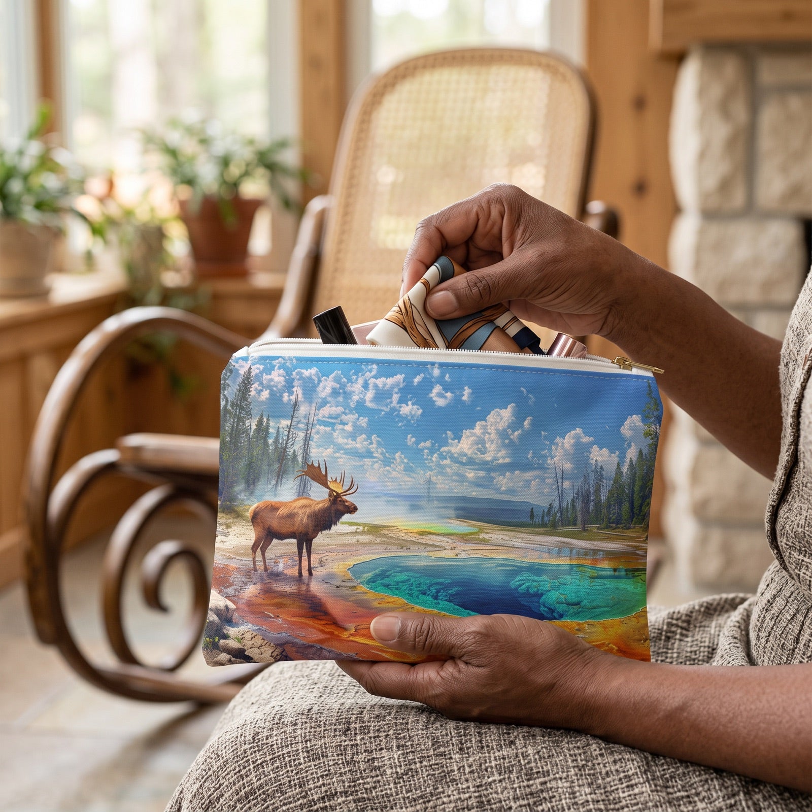 Small Yellowstone Serenity accessory pouch (8.35 × 5.98 inches) in use: older woman folds a silk hair scarf small and slides it into pouch on her lap. Lifestyle mockup with hands showing scale.