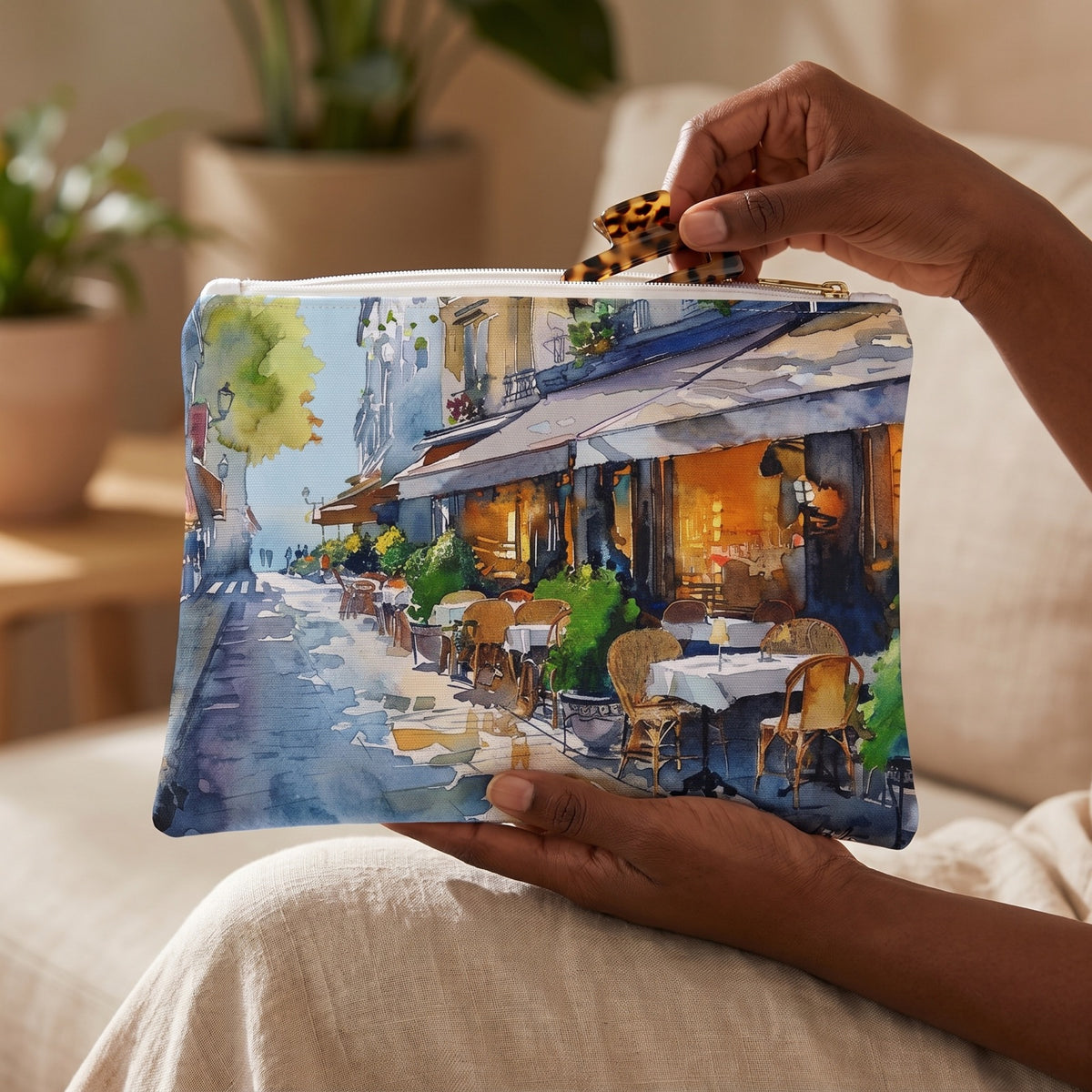 Small Parisian Bistro Bliss accessory pouch (8.35 × 5.98 inches) in use: woman takes a hair clip from pouch cradled in her hand. Lifestyle mockup with hands showing scale.