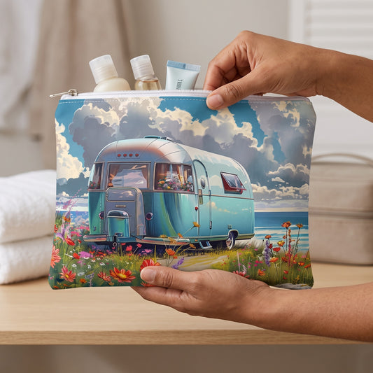 Large Retro Beach Bliss accessory pouch (11.81 × 8.35 inches) in use: woman packs travel-size toiletries into pouch before placing it in a weekend case. Lifestyle mockup with hands showing scale.
