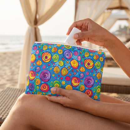 Small Color Whirl accessory pouch (8.35 × 5.98 inches) in use: woman retrieves a tiny sunscreen stick from pouch on her lap. Lifestyle mockup with hands showing scale.