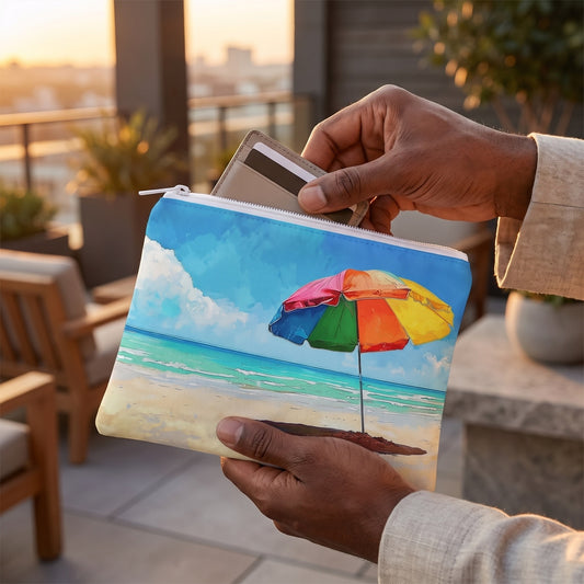 Small Tropical Tranquility accessory pouch (8.35 × 5.98 inches) in use: man slips a card wallet and keycard into pouch, linen jacket cuff visible. Lifestyle mockup with hands showing scale.