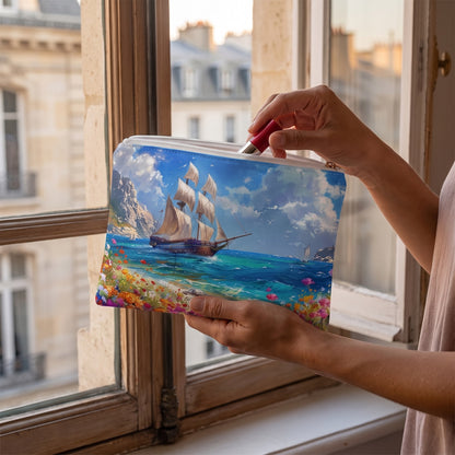 Small Sail Away into History accessory pouch (8.35 × 5.98 inches) in use: woman retrieves a lipstick from pouch on her palm with city rooftops blurred. Lifestyle mockup with hands showing scale.