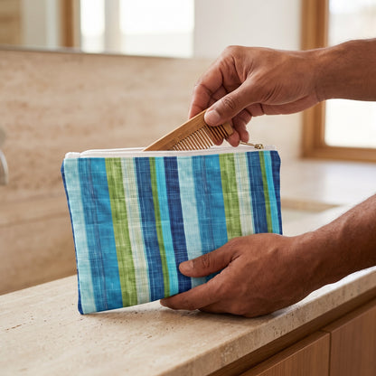 Small Ocean Whisper Stripes accessory pouch (8.35 × 5.98 inches) in use: man takes a travel grooming comb from pouch supported by his other hand. Lifestyle mockup with hands showing scale.