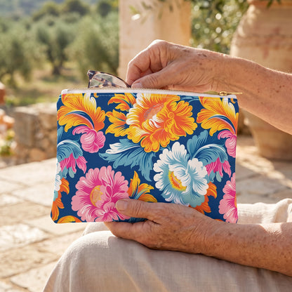 Small Chintz Charm accessory pouch (8.35 × 5.98 inches) in use: older woman's hand retrieves reading glasses from the gently filled pouch resting on her lap. Lifestyle mockup with hands showing scale.