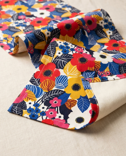 Blossom Burst table runner close-up — cotton twill front with natural cotton reverse and hemmed edge