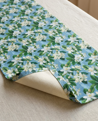 Jasmine Whisper table runner close-up — cotton twill front with natural cotton reverse and hemmed edge