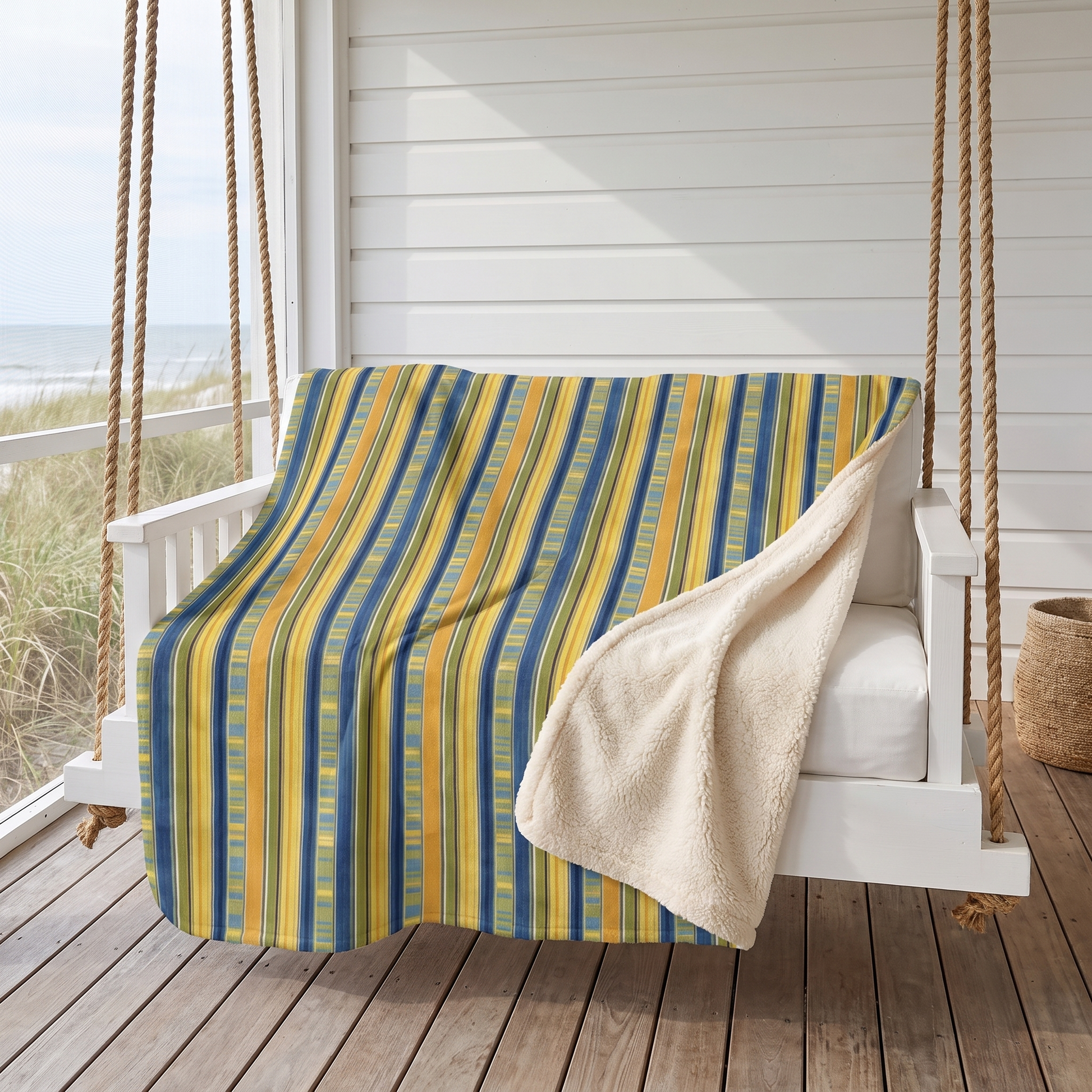 Summer Stripes Delight sherpa fleece blanket on a hanging porch daybed by the sea