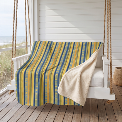 Summer Stripes Delight sherpa fleece blanket on a hanging porch daybed by the sea