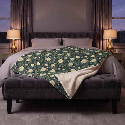 White Roses at Dusk sherpa fleece blanket on a charcoal velvet bench in evening lamplight