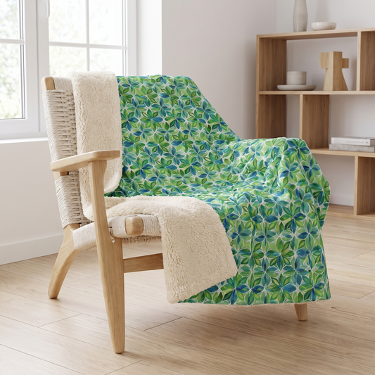 Spring Geo Flowers sherpa fleece blanket on a blond-wood armchair in a Scandinavian living room