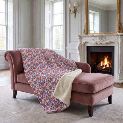 Regal Blossom sherpa fleece blanket on a dusty-rose chaise in a stately drawing room