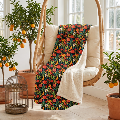 Blooming Bird Wonderland sherpa fleece blanket on a hanging rattan swing chair in a bright orangery