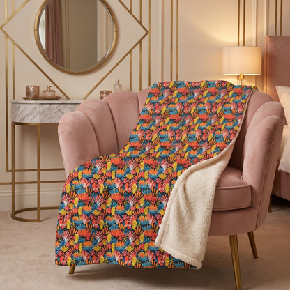 Coral Plume sherpa fleece blanket on a blush velvet chair in an art-deco boudoir