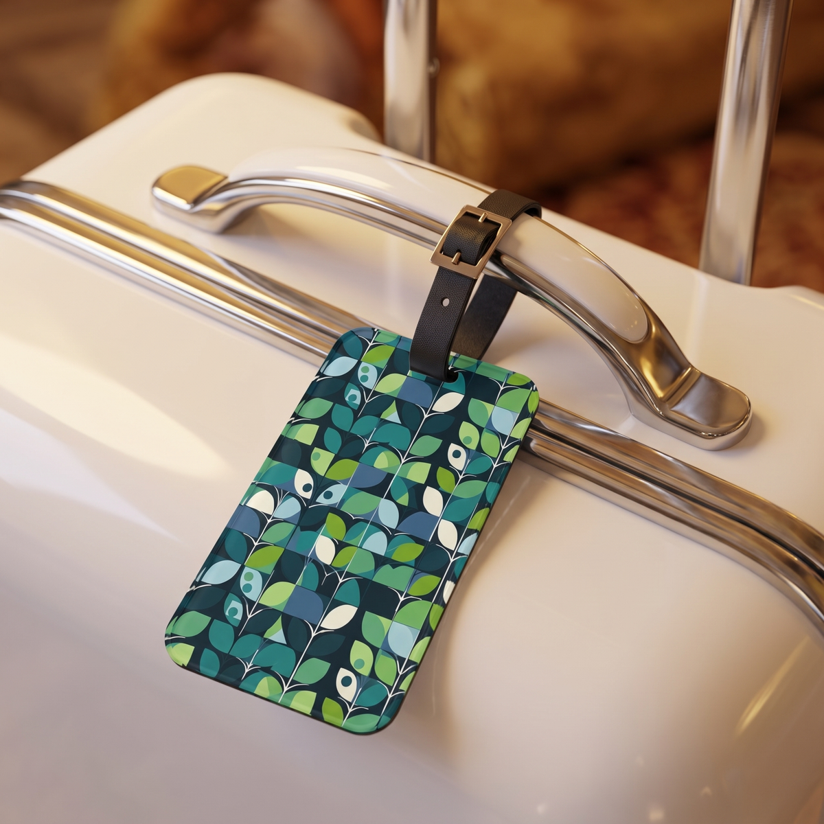 1960s Groovy Mod acrylic luggage tag at true size on the handle of a white retro hard-shell suitcase