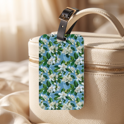 Jasmine Whisper acrylic luggage tag at true size on an ivory leather vanity case