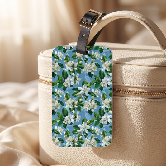Jasmine Whisper acrylic luggage tag at true size on an ivory leather vanity case