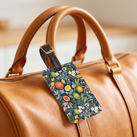 Magical Fruitiness acrylic luggage tag at true size on a honey-tan leather weekender