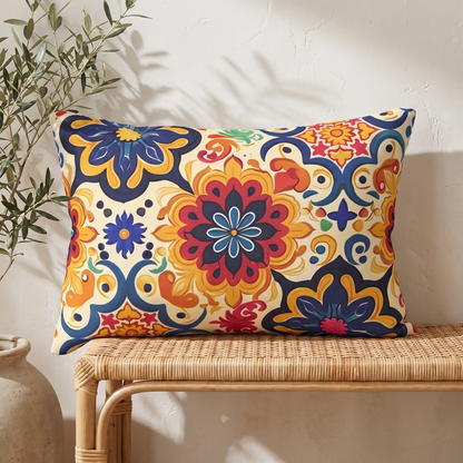 Moorish Mosaic Majesty Lumbar Pillow on a rattan bench against a warm white plaster wall with an olive branch