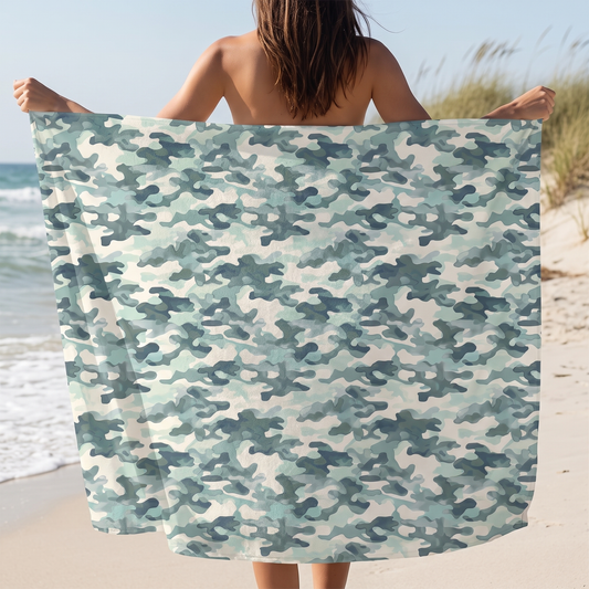 CamoGroove Luxurious Beach Towel held open at the beach, showing the full soft-green camouflage print