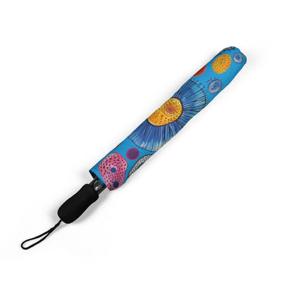 Primordial Sea Life umbrella folded closed, showing the printed canopy and wrist strap