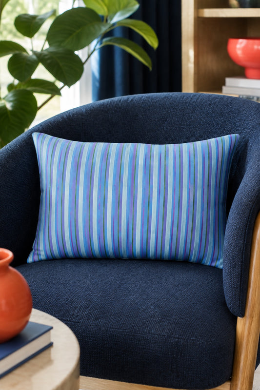 Stripe Hype lumbar pillow with blue striped design in a modern navy reading chair